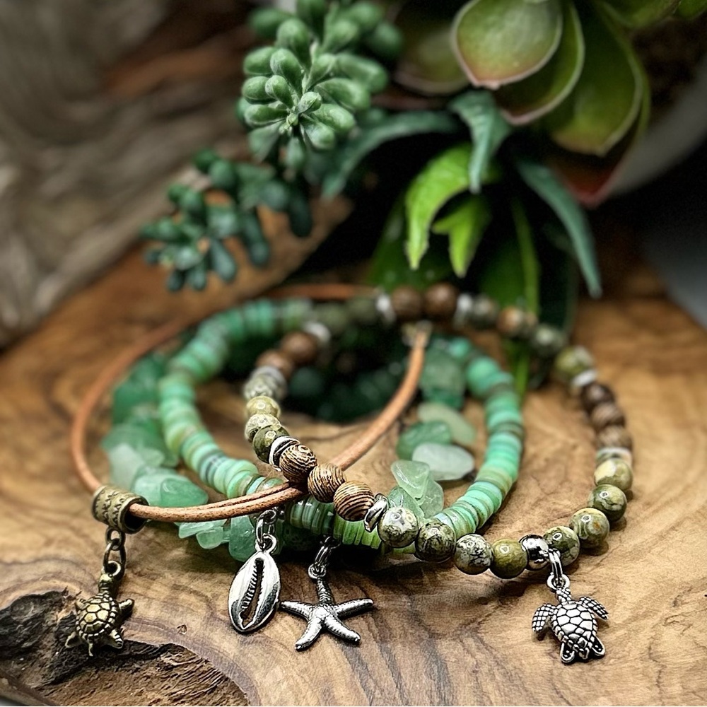 Green Semiprecious Beaded Bracelets with Charms and leather bracelet.